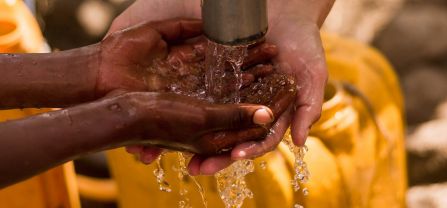 Washing hands with clean water from a tap